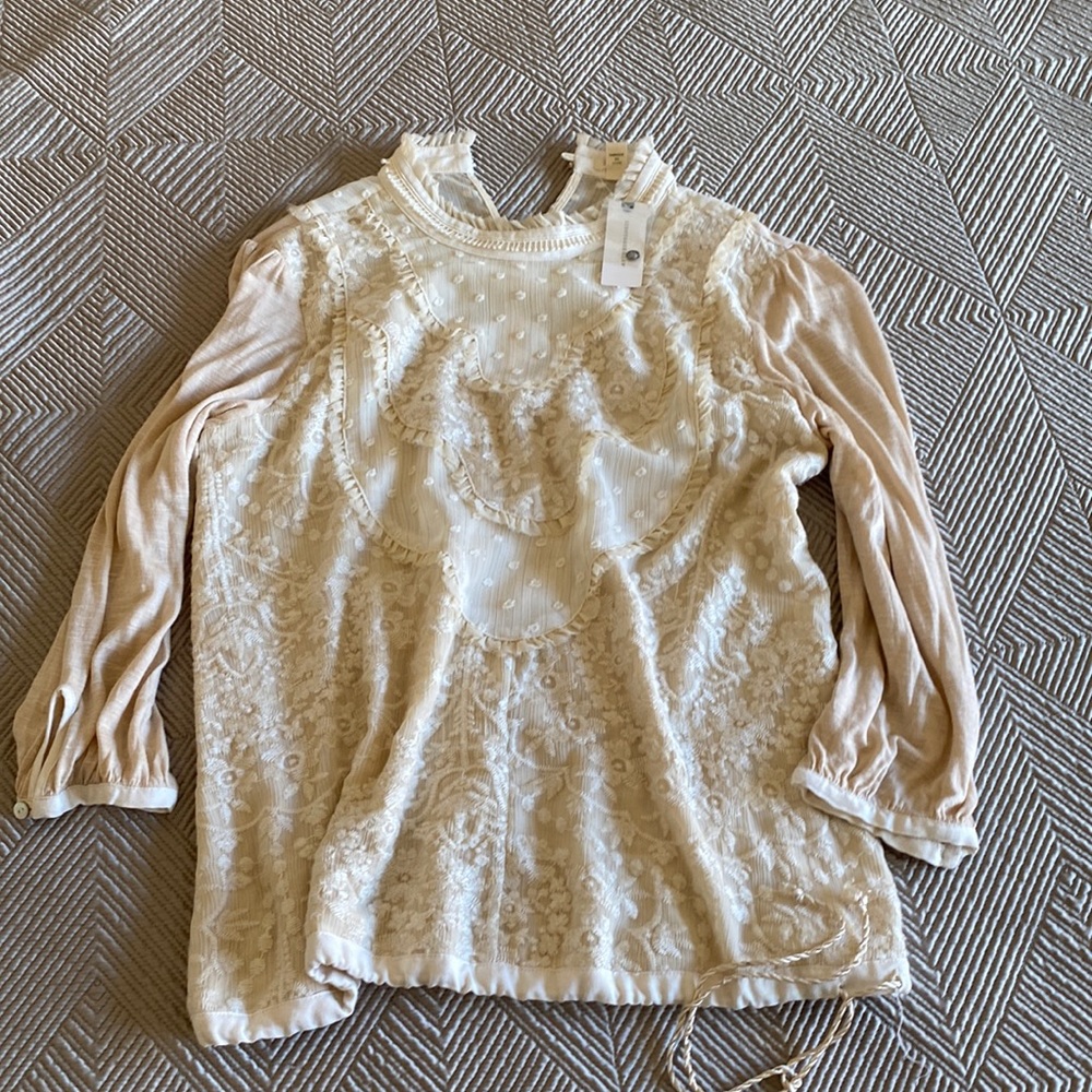 Beautiful blouse from Anthropologie, Brand is Tiny.